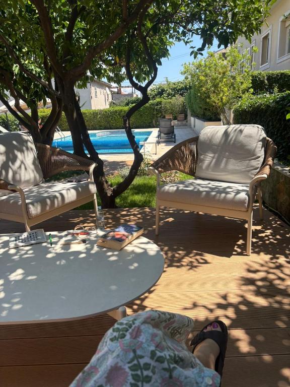 a person laying on a patio with a table and chairs at Villa Bakica in Trogir