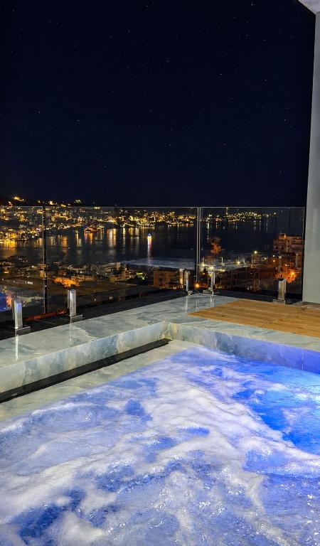 a hot tub on top of a building at night at Denis Apartments in Sarandë
