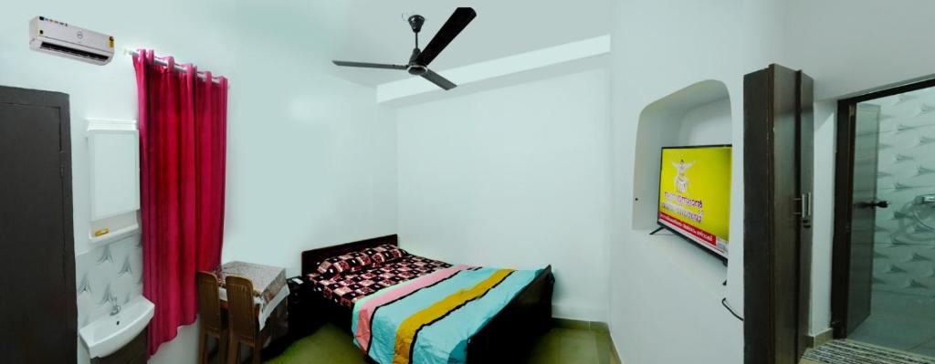 a bedroom with a bed and a clock on the wall at Railviewtouristhome in Varkala