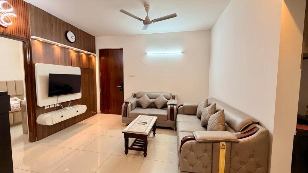 a living room with a couch and a tv at Krishna Cottage 3BR Apt By Amoret Homes in Chicalim