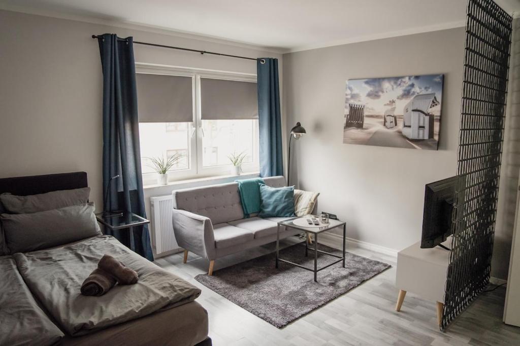 a living room with a couch and a window at Apartment Nr 06 in Bremerhaven