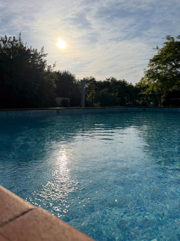 a pool of water with the moon in the sky at Casa Jeyel in Lazise