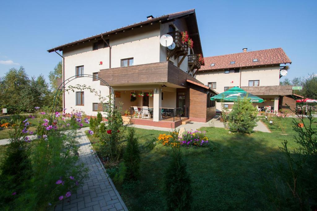 a large house with a garden in front of it at Royal Hotel in Drăguş