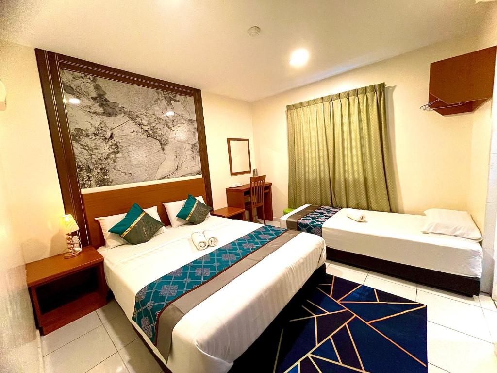 a hotel room with two beds and a window at Near Jonker Street - JCITYHOTEL - FREE PARKING in Malacca