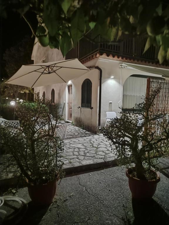 an umbrella in front of a house at night at La casa Bianca in Maratea