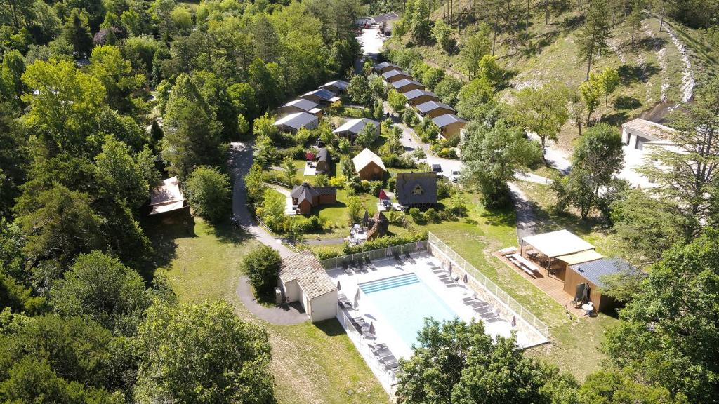 an aerial view of a house with a swimming pool at Camping La Ferme de Castellane in Castellane