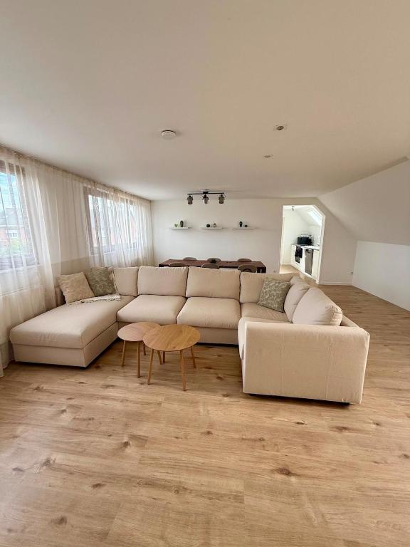 a living room with a couch and a table at Het Schuttershof in Hoogstraten