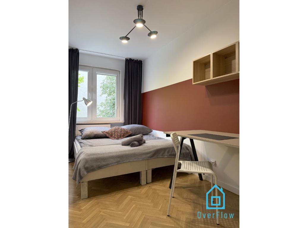 a small bedroom with a bed and a desk at Harbor Room at City Center Gdynia & Seaside in Gdynia