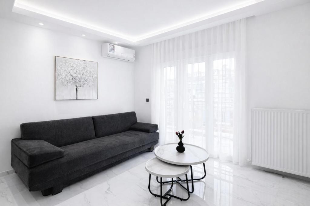 a living room with a couch and a table at Agias Sofias Luxury Apartments in Thessaloniki
