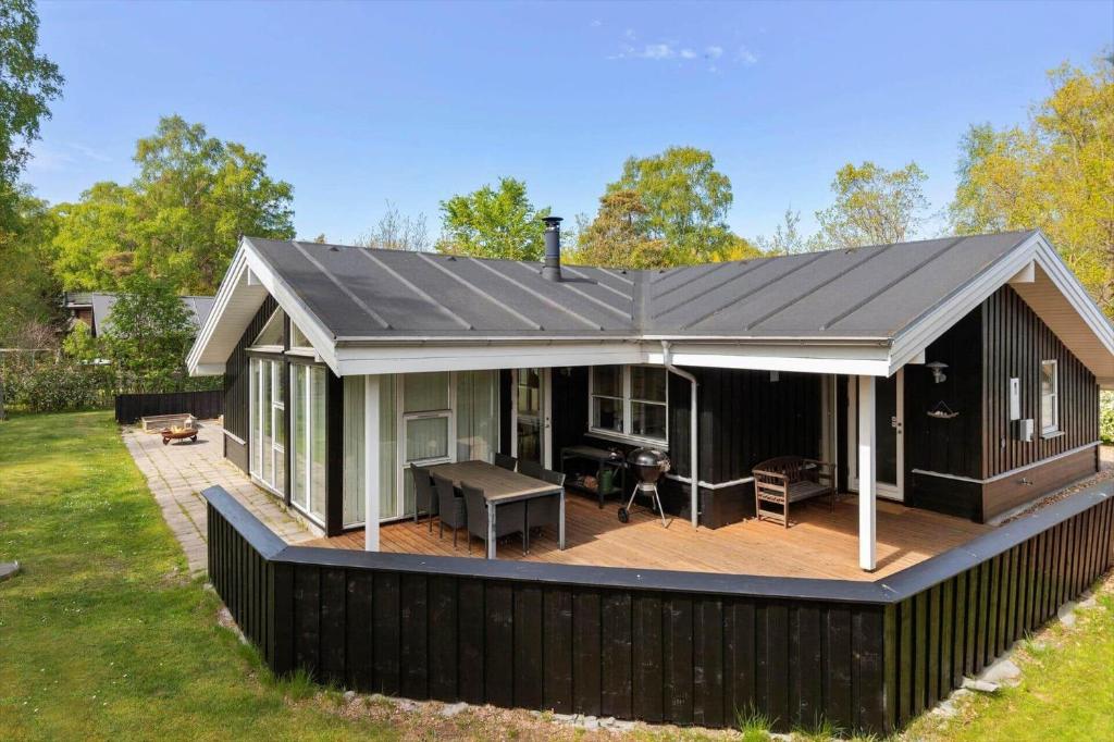 a house with a deck with a pitched roof at 8522-Grenaa-Nobilisvej-15 in Grenå