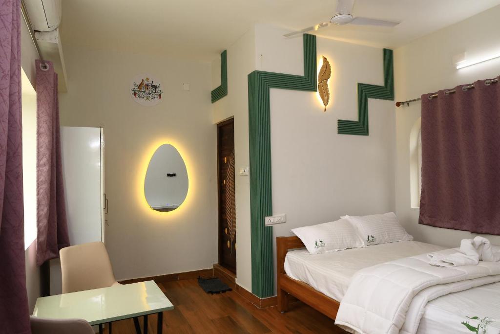 a bedroom with a bed with a cross on the wall at The Aussie House in Mahabalipuram