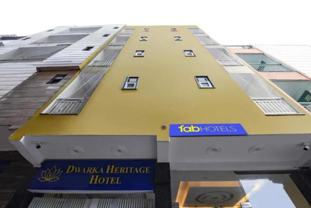 a yellow building with a sign in front of it at FabHotel Dwarka Heritage in New Delhi