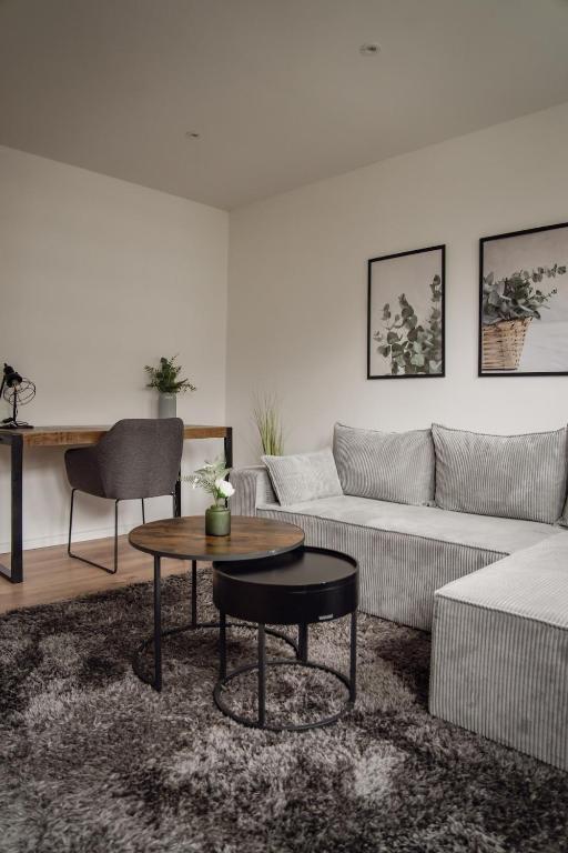a living room with a couch and a table at Apartment Claussen 2 in Bremerhaven