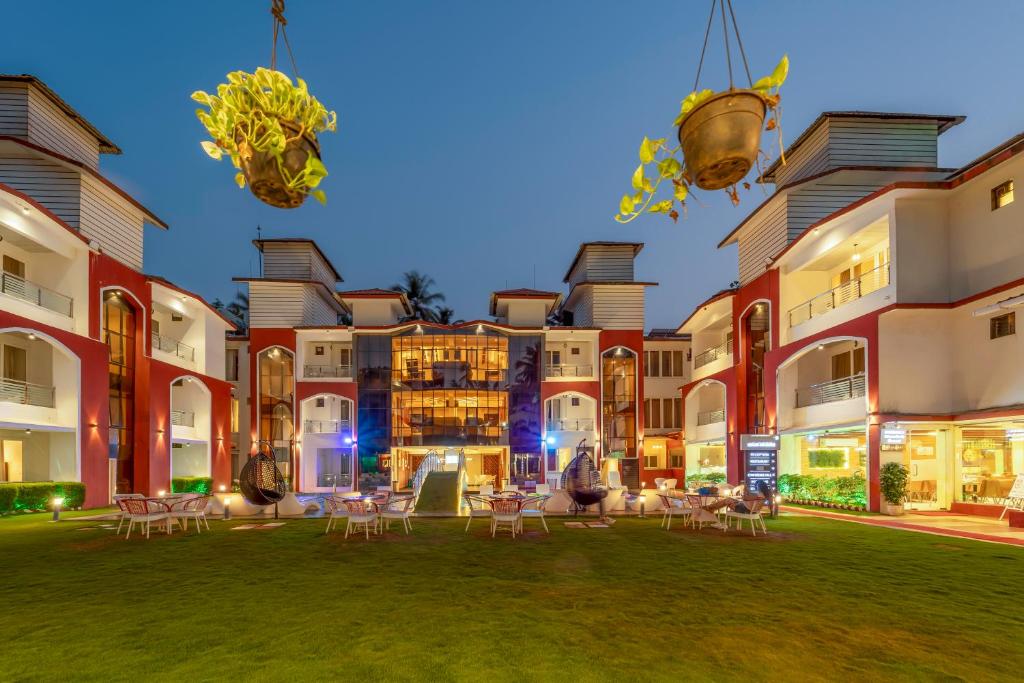 a courtyard with chairs and tables in front of a building at Hotel Shanti Solitaire, Arpora in Arpora