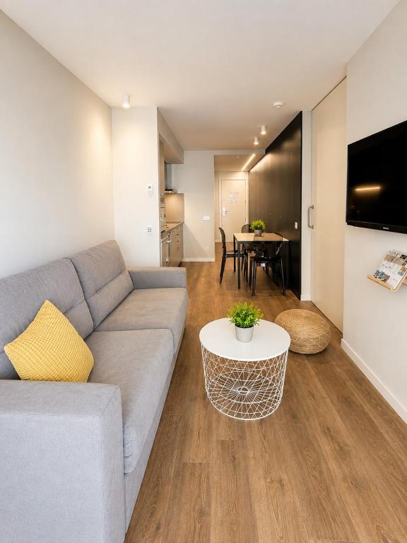 a living room with a couch and a table at Apartaments Turístics Conseller in Andorra la Vella