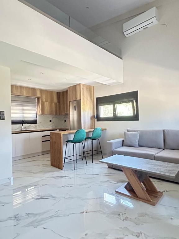 a living room with a couch and a table at Villa Ziglos by Karda Suites in Chios
