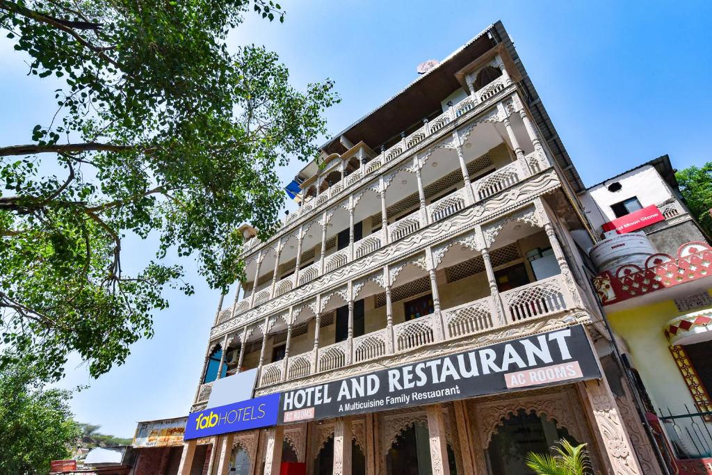 a building with a sign that reads hotel and restaurant at FabHotel Moon Stone, Near Jawahar Circle - World Trade Park in Jaipur