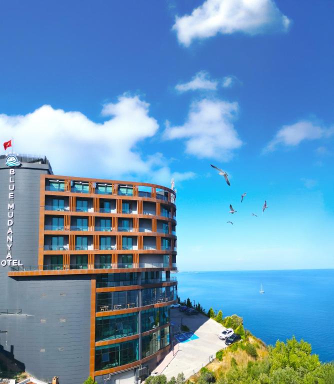 a hotel on a hill next to the ocean at BLUE MUDANYA HOTEL in Bursa