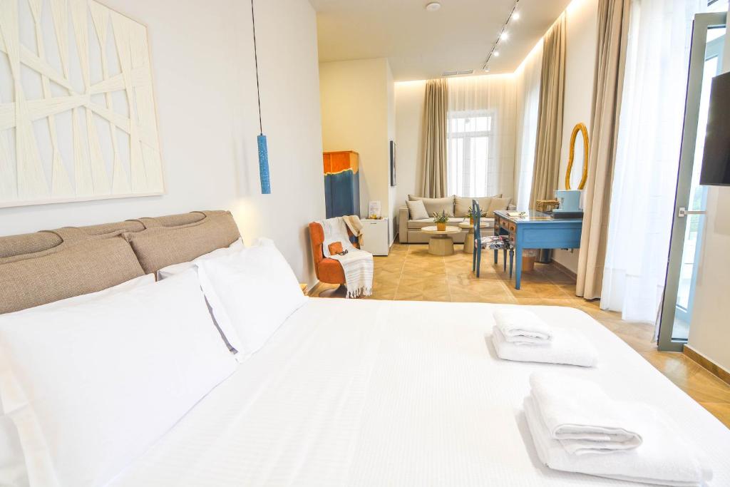 a bedroom with a bed and a living room at Evilion Suites in Xylokastro