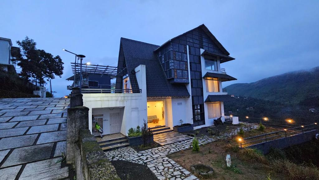 a house on top of a hill at night at Celestial Nymph by Natureloom in Vagamon