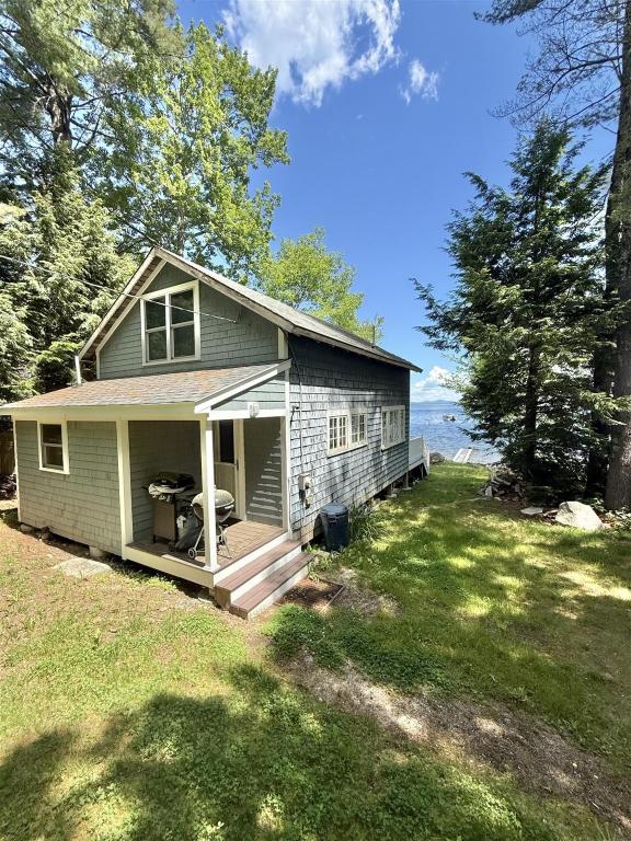 a small house with a porch on a lawn at ROCKY BEACH LIMIT 5 cabin in Standish