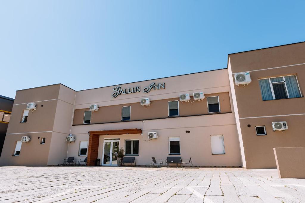 a building with a sign on the front of it at Gallus Inn in Aleksinac