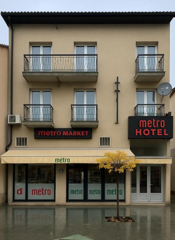 a hotel with a tree in front of it at METRO Hotel in Gusinje