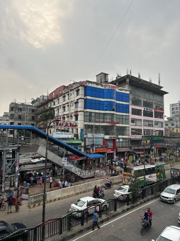 a busy city street with cars and people and buildings at Hotel Sunrise Int in Dhaka