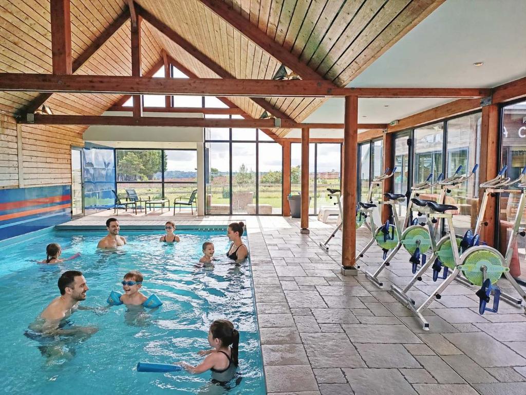 a group of people in a swimming pool at Les Gîtes du Pêcheur in Erquy