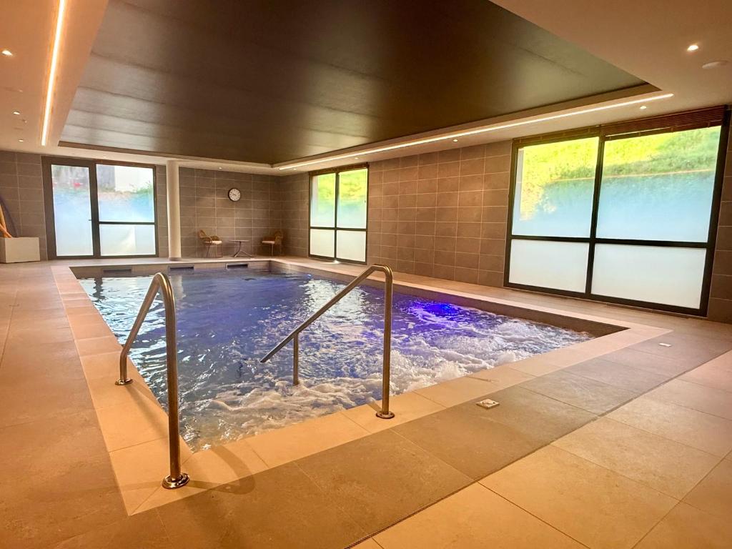 a large indoor swimming pool in a house at DOMITYS - L'Alezane in Saint Lo