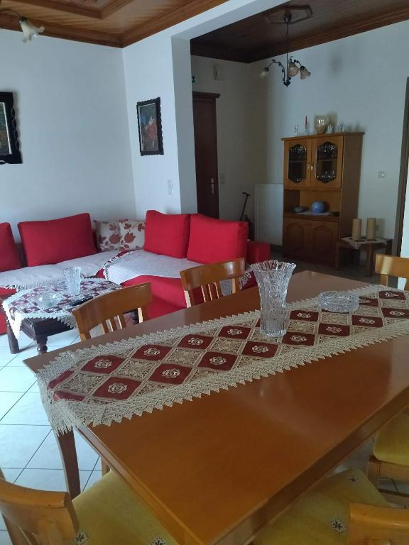 a dining room with a table and a couch at Theasi in Konitsa