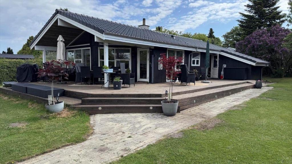 a house with a large wooden deck in the yard at 30035-Malling-Pilelokken-16 in Malling