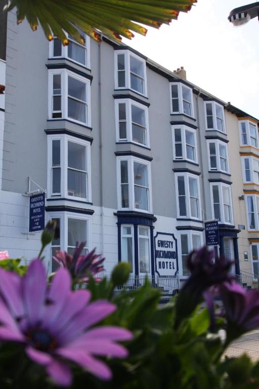 a white building with flowers in front of it at Richmond Hotel in Aberystwyth