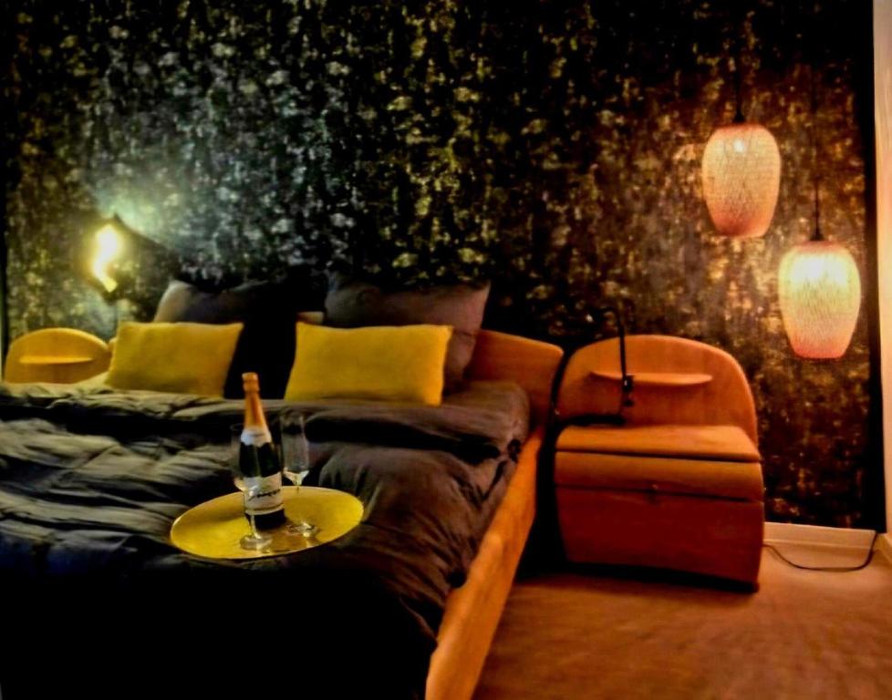 a bedroom with a couch with a bottle of wine on it at Fewo Schwarzwald Von Oben - Kniebis in Freudenstadt