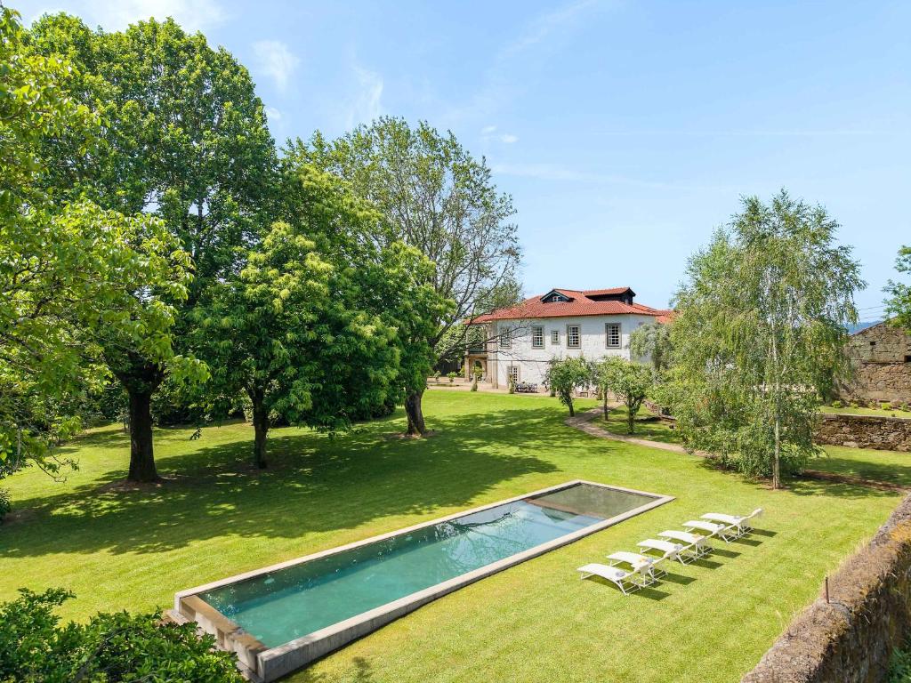 a swimming pool in the yard of a house at Carcavelos Manor House by Portugal Active in Vila Verde