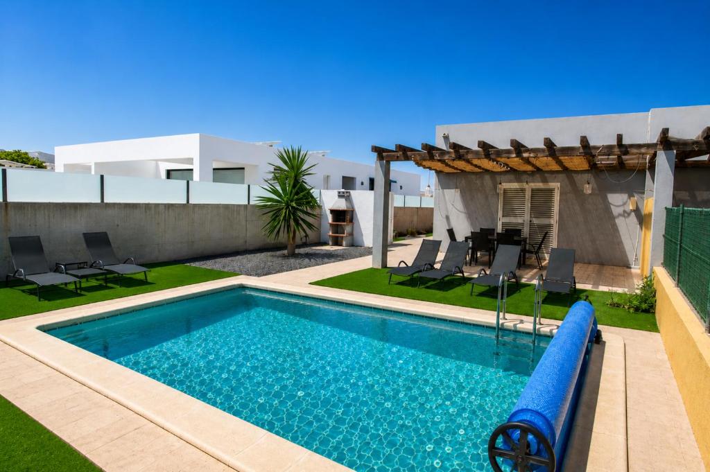 a swimming pool with a slide in a backyard at Aurea 1 Luxury House in Antigua