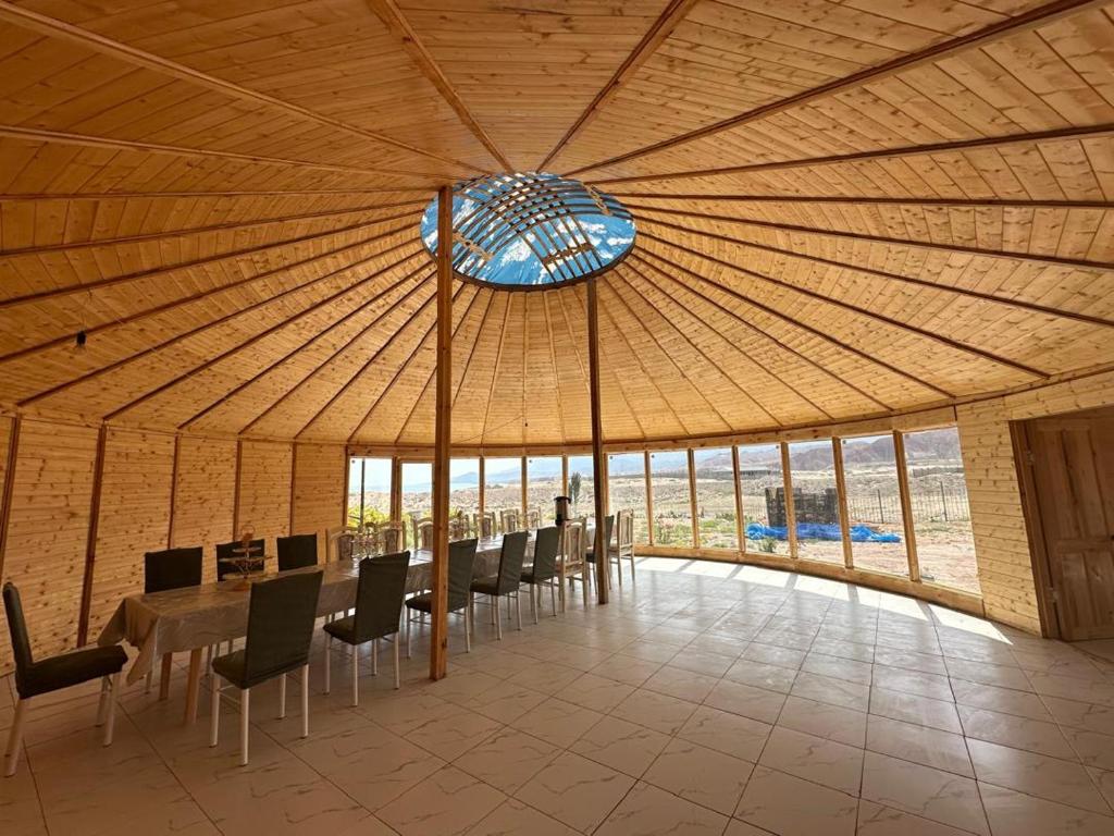 a large room with a table and chairs and a glass ceiling at Guesthouse'Hadicha' in Tong