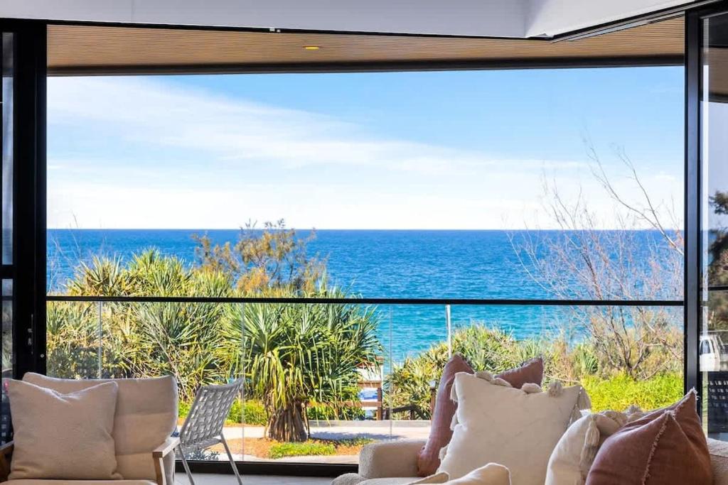 a living room with a view of the ocean at Coolum First Bay 121 in Coolum Beach