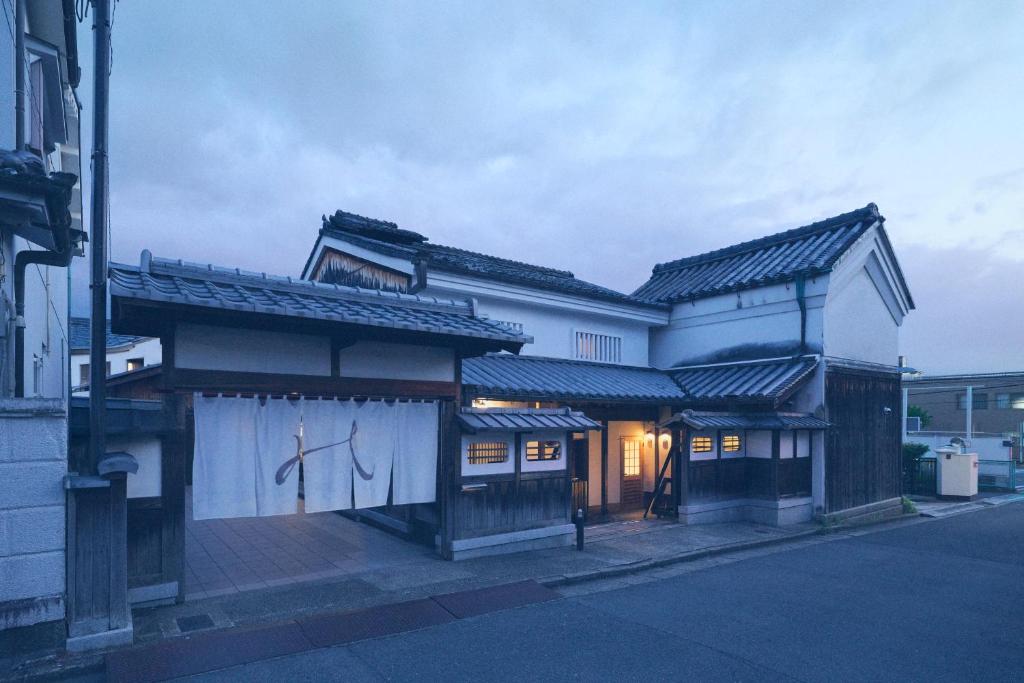 an asian building with a gate in the street at Kazeno Naramachi formerly NIPPONIA HOTEL NARA NARAMACHI in Nara
