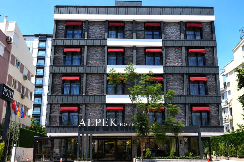 an apartment building with a sign that reads all peak hotel at Alpek Hotel Antalya - Lara in Antalya