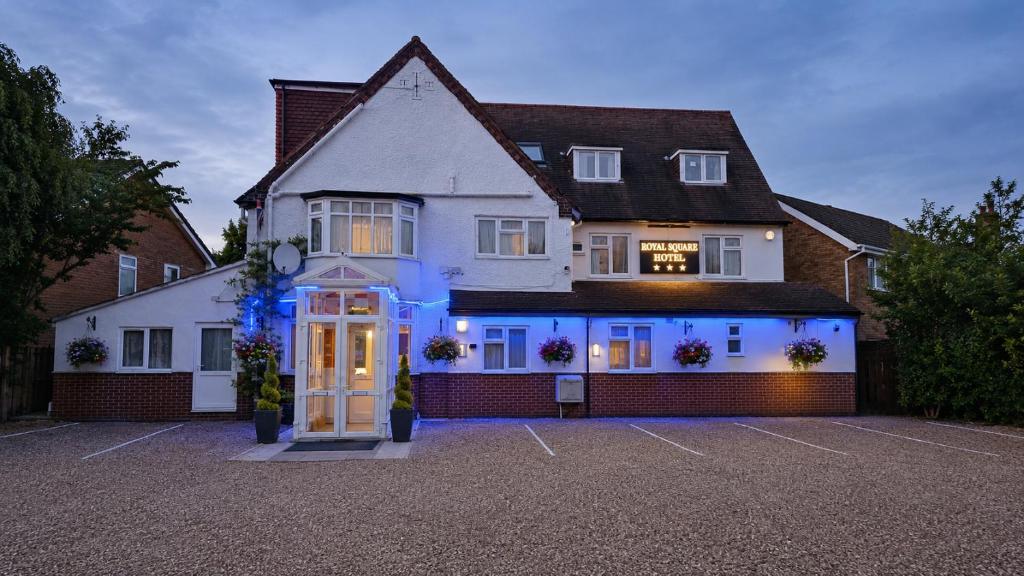 a house with blue lights on the front of it at Royal Square Hotel - NEC & Birmingham Airport in Marston Green