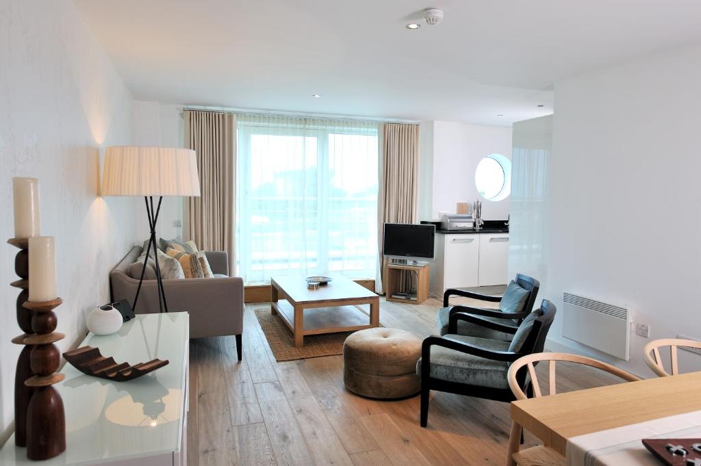 a living room with a couch and a table at St Moritz Hotel and Cowshed Spa in Polzeath