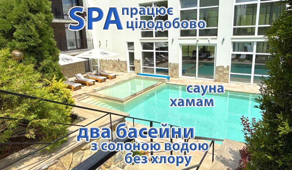 a swimming pool in front of a building at LOFT Hotel & SPA in Bukovel