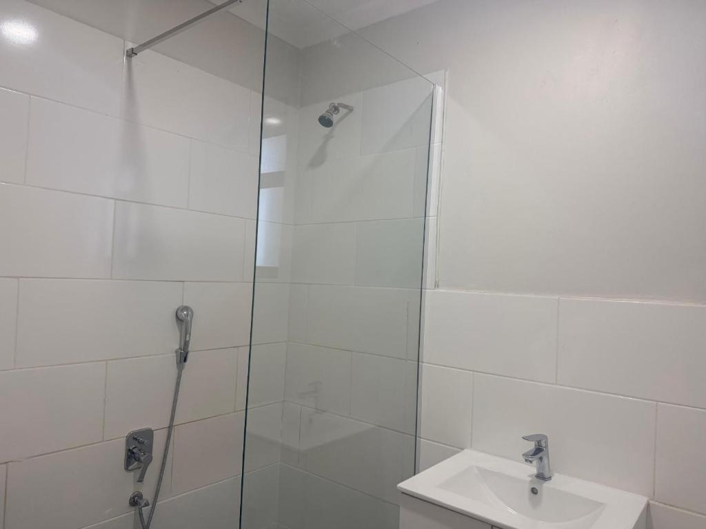 a bathroom with a shower and a sink at Dreams Apartments in Victoria Falls