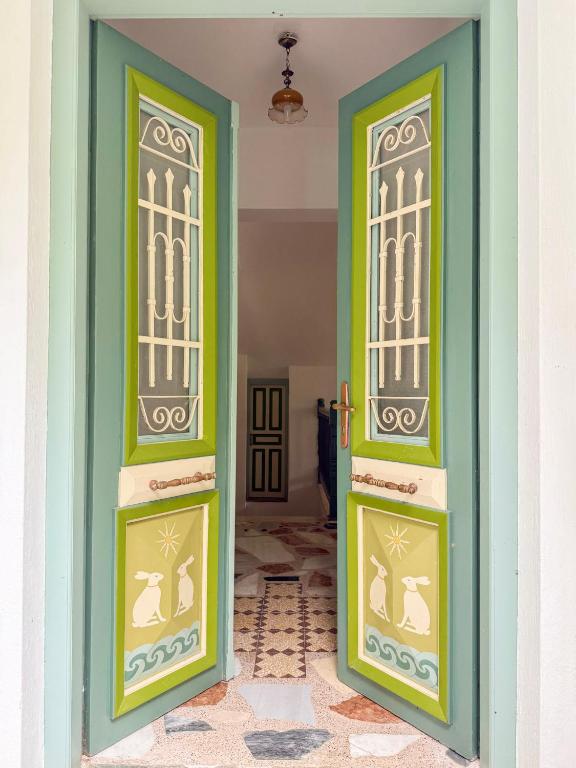 two doors in a room with green at LAGO Skiathos Guest Suites in Skiathos