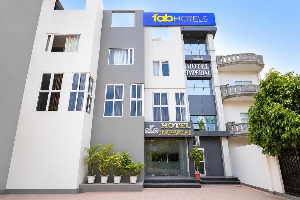 a white hotel with a sign on the front of it at Fabhotel Imperial 900 m from Sarnath Museum in Varanasi