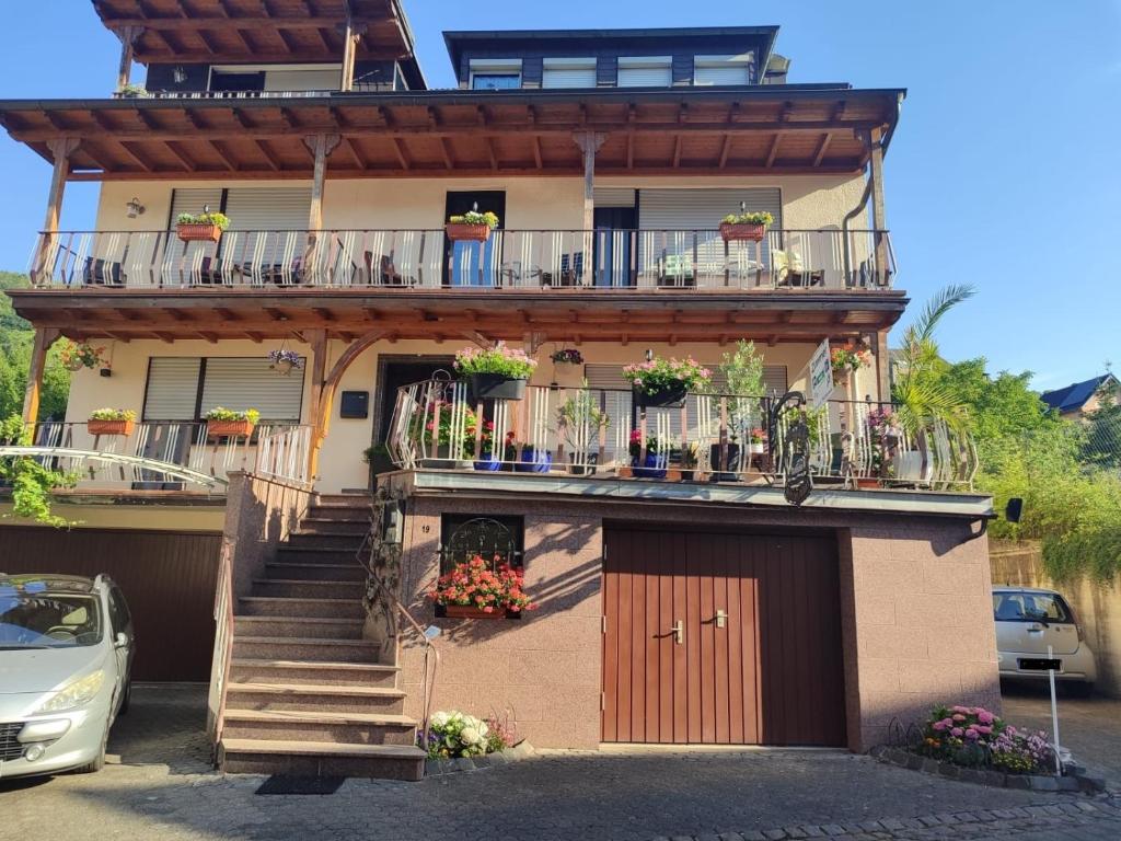 a building with a balcony with flowers on it at Haus Milaneva in Klotten