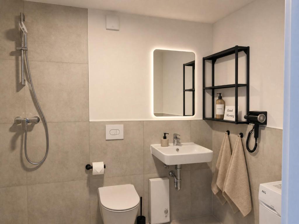 a bathroom with a toilet and a sink and a shower at CityNest Apartment Mülheim in Mülheim an der Ruhr