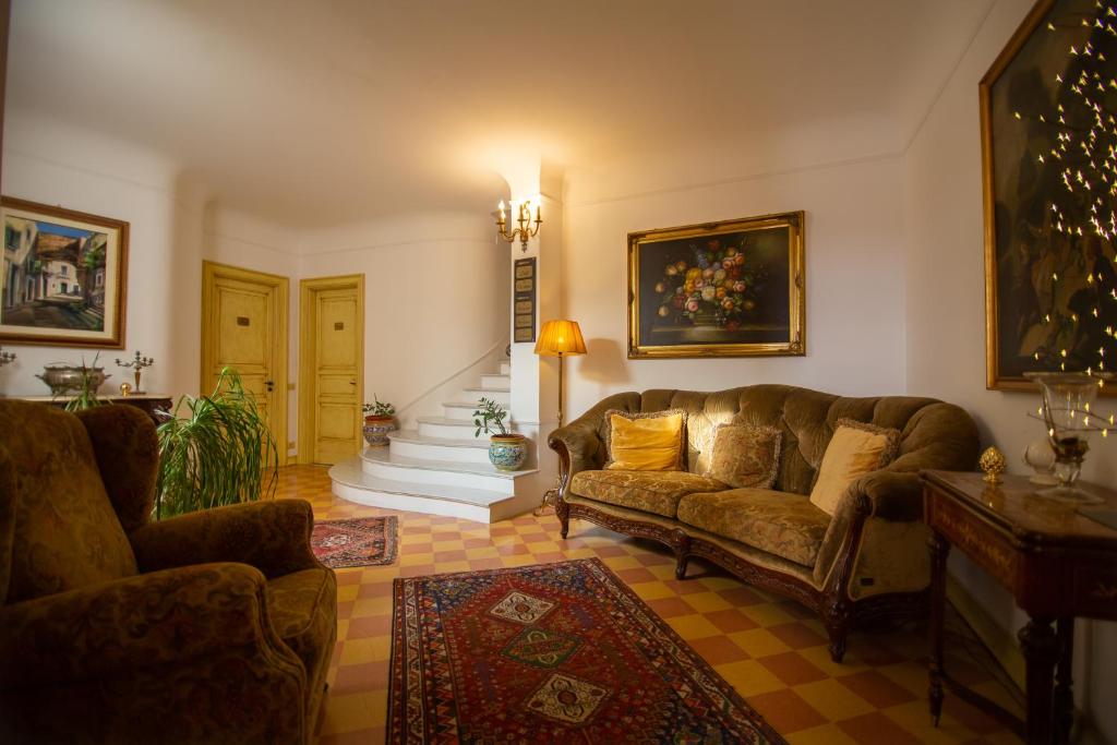 a living room with a couch and a staircase at Atenea Luxury Suites - Atenea Collection in Agrigento