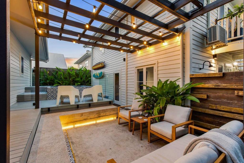 an outdoor patio with chairs and a pergola at La Mer in Marcoola in Marcoola